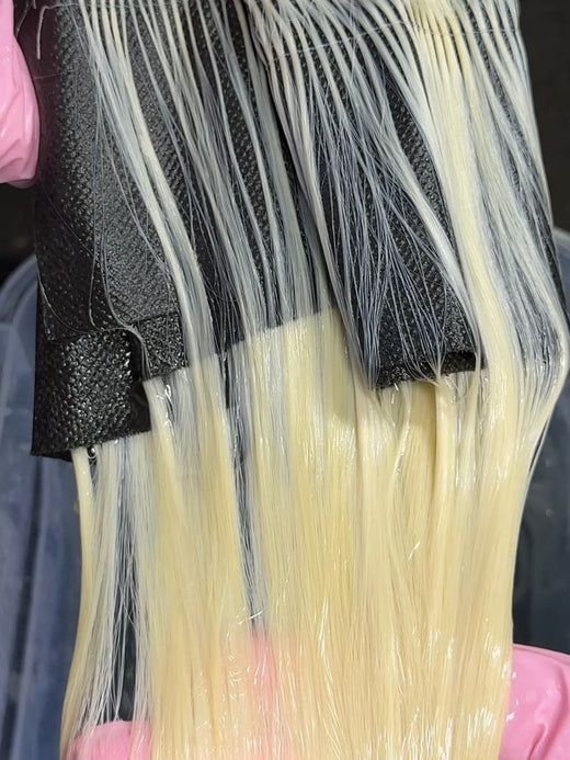 Toner applied to a bleached hair weft to neutralize yellow